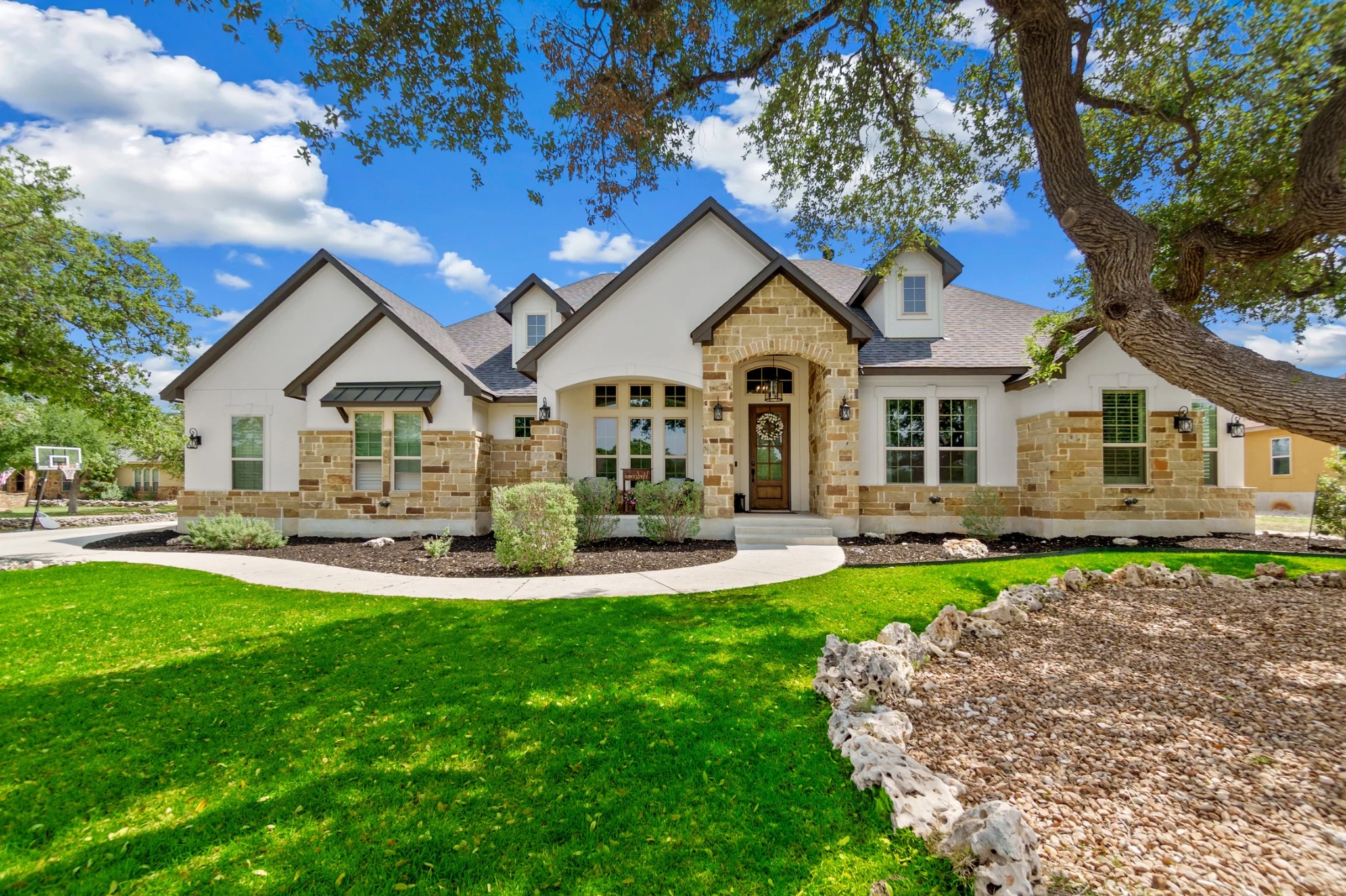 Well-kept Texas residential property with limestone exterior and landscaped lawn