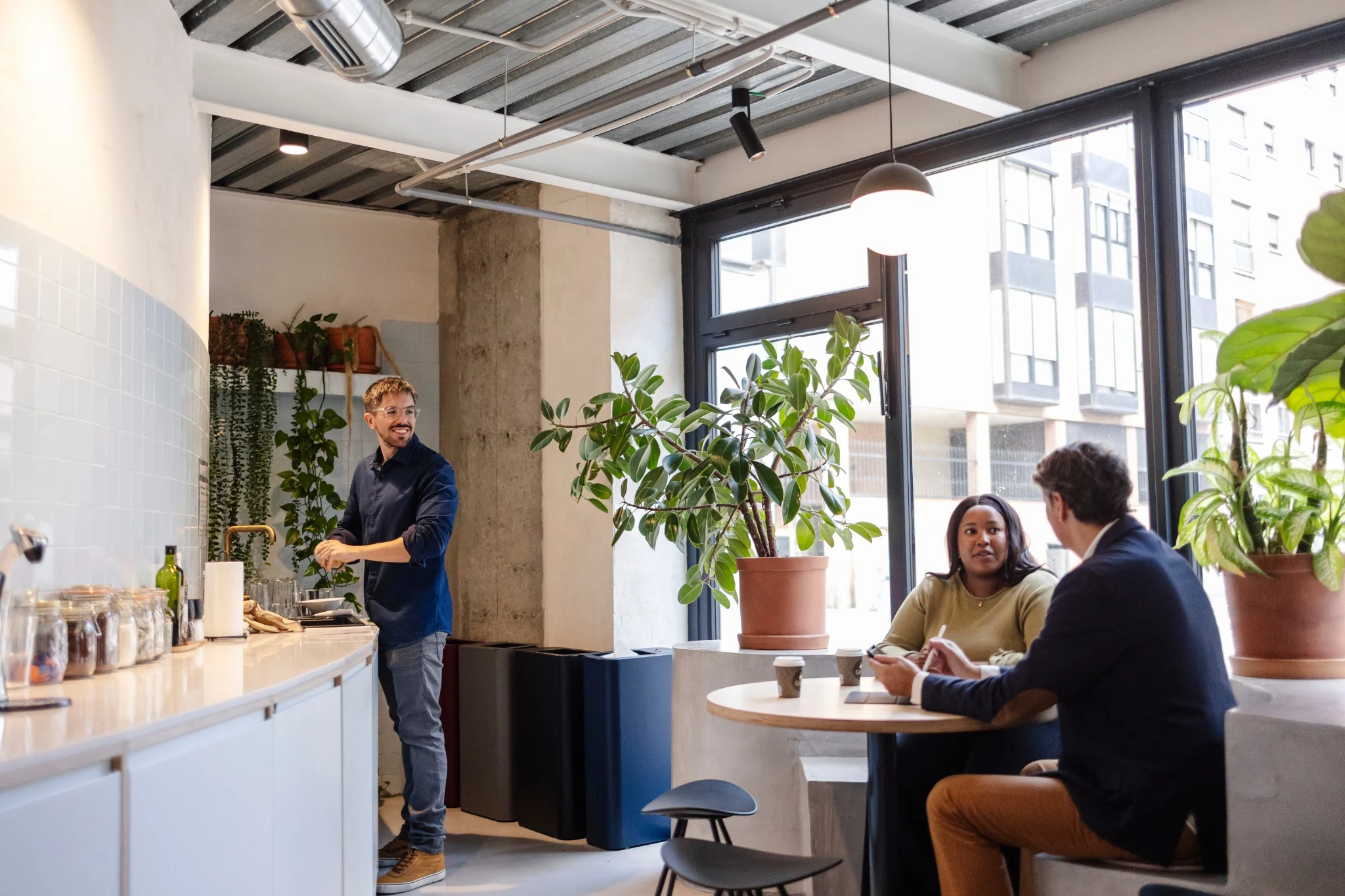 Bright employee breakroom with kitchenette and seating